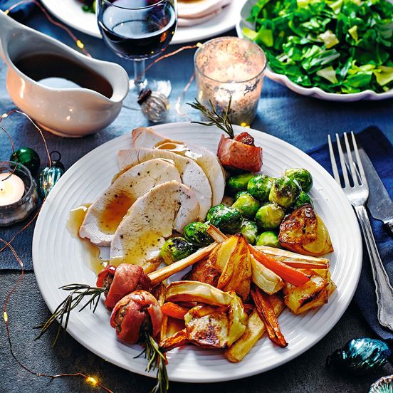 Turkey with roasted roots, stuffing parcels and Parmesan sprouts