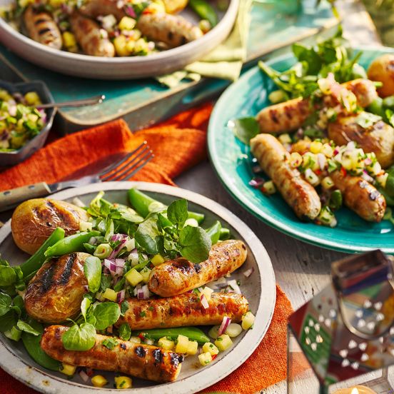 Barbecue sausages with pineapple salsa, roast potatoes and watercress